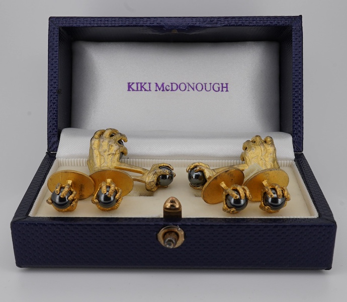 A modern gilt sterling and hematite set six piece dress stud set, modelled as a hand grasping a sphere, comprising a pair of cuff links 30mm and four studs. Condition - poor to fair